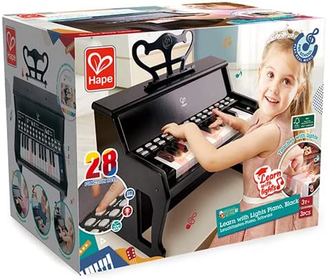 Packaging for a black toy upright piano with 28 light-up keys, featuring a girl playing and the Hape brand logo.