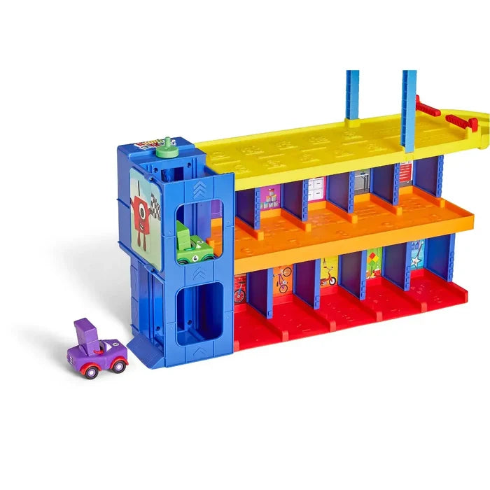 Colorful three-story toy garage with numbered bays, a blue elevator tower, and purple and green character cars.
