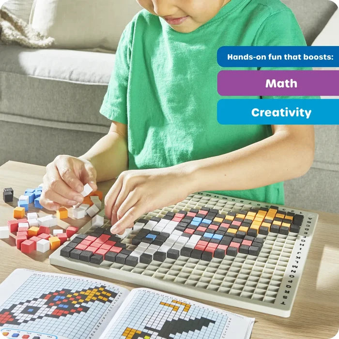A child uses small colorful cubes on a numbered grid board to build pixel art, following an instruction booklet.