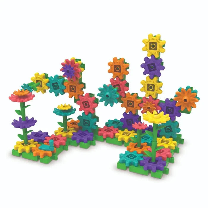 Interlocking colorful gears, stems, and flower petals forming a vertical garden structure on green baseplates.