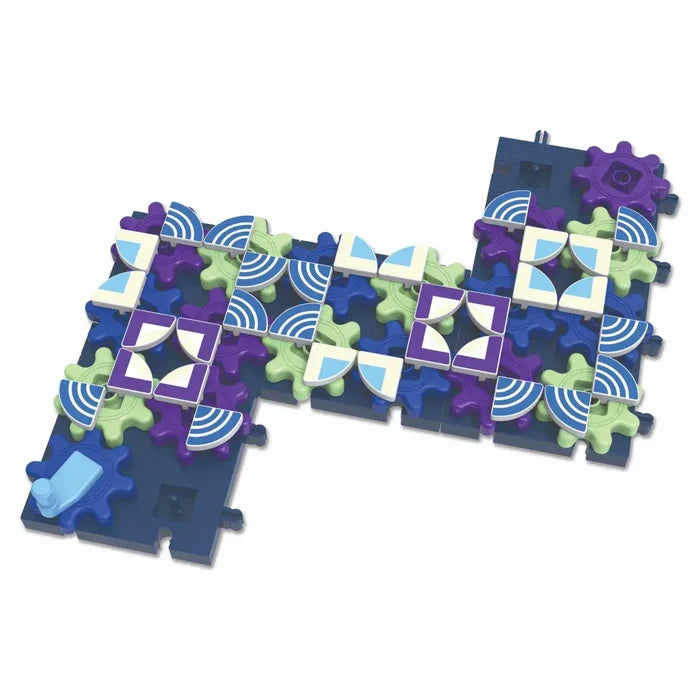 Interlocking dark blue base with purple and green gears topped with patterned white and blue tiles and a turning handle.