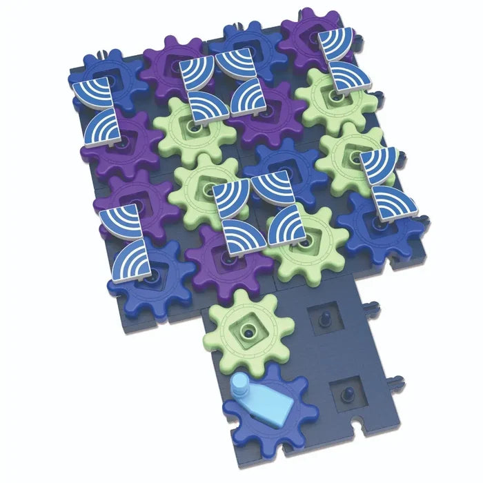 Interlocking purple, green, and blue toy gears on a dark blue base with patterned squares and a light blue handle.