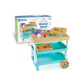 Teal and tan toy kitchen island with play food and baskets, shown next to its product box.