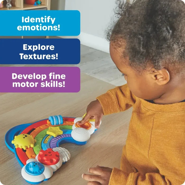 Toddler playing with a colorful rainbow sensory board with textured buttons and beads. Text details developmental benefits.