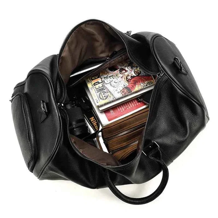 Leather business travel bag by Mead's Supply & Equipment Outfitters, black premium duffel with multiple compartments and bronze accents.