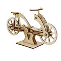 Laser-cut light wood bicycle model with visible gears and wheels, standing on a matching rectangular base.