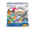 Box showing children playing on a colorful floor grid with arrows and robot cutouts for interactive STEM play.