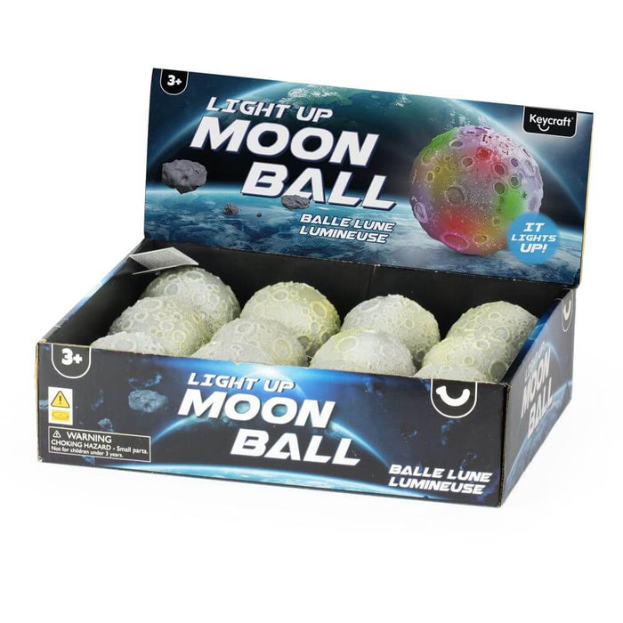 Textured grey cratered toy balls in a blue space-themed display box with colorful glowing moon graphics.