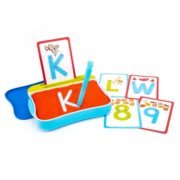 Blue tray with orange sand, a stylus tracing a glowing letter K, and colorful alphabet and number cards.
