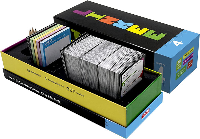 Open trivia game box with yellow base and black lid, filled with stacks of question cards, score pads, and small pencils.