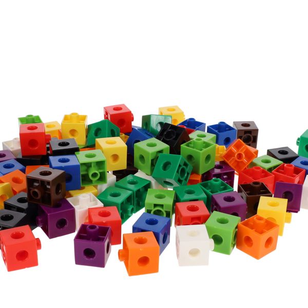 A scattered heap of colorful plastic linking cubes in assorted colors, each with connector pegs and holes.