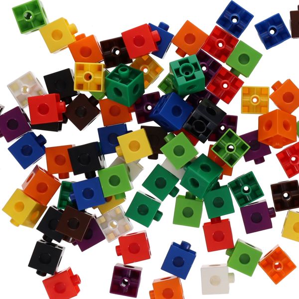 Scattered pile of vibrant, multi-colored plastic interlocking cubes featuring circular holes and connection pegs.