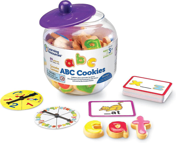 Clear jar of colorful plastic alphabet cookies with game spinners and word-building activity cards.