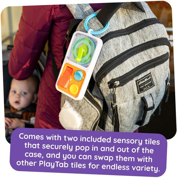 White sensory toy with interchangeable green gear and button tiles clipped to a gray backpack using a blue ring.