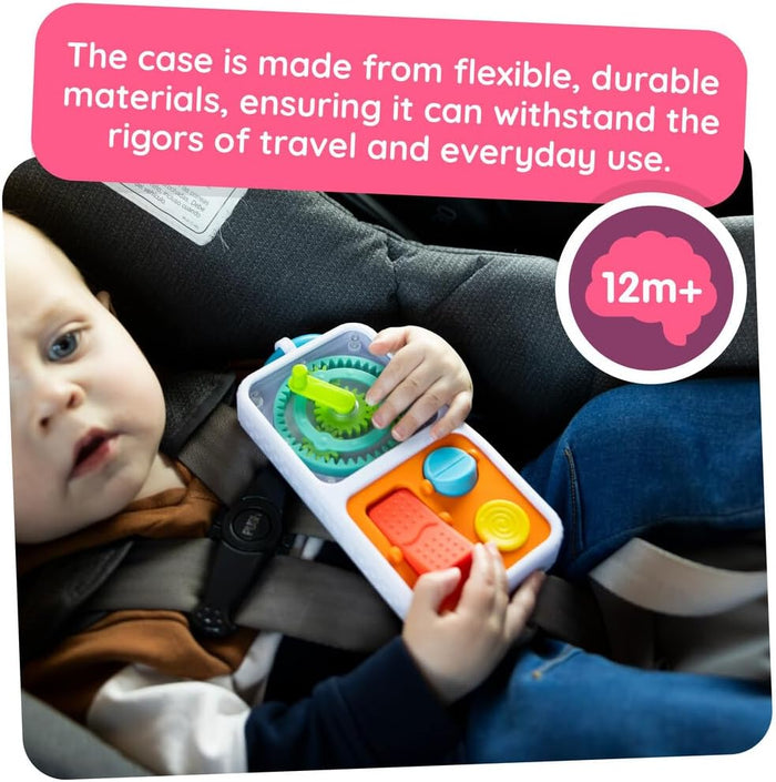 Toddler in a car seat playing with a white activity toy featuring interlocking green gears and orange buttons.