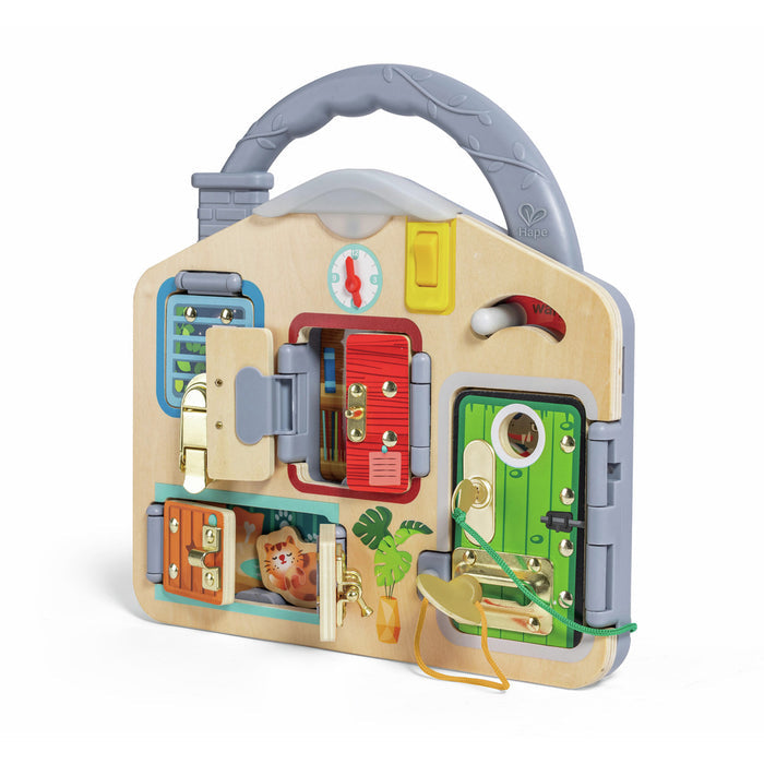 House-shaped wooden activity board with colorful doors, metal locks and latches, a clock, and a grey handle.