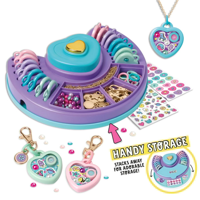 Purple and blue heart-shaped craft studio with colorful beads, charms, and stickers to create custom locket jewelry.