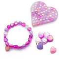 Pink and purple heart-beaded bracelet with matching heart-shaped tray and loose iridescent heart beads.