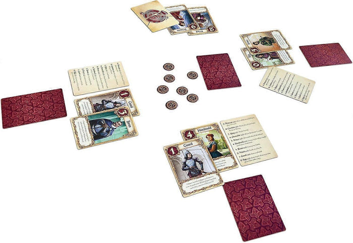 Illustrated character cards, patterned red card backs, and circular favor tokens spread across a white surface.