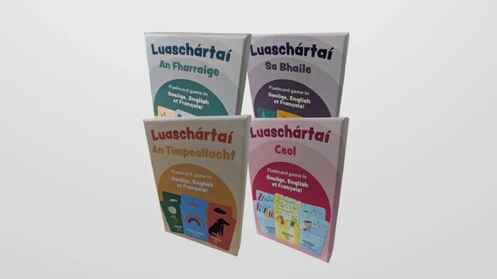 Four colorful flashcard boxes in blue, purple, orange, and pink with Irish language titles and card illustrations.