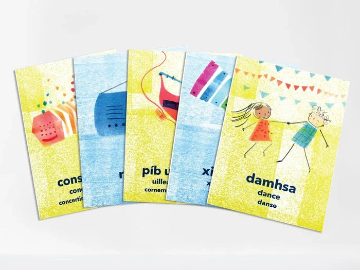 Five fanned-out Irish flashcards with yellow and blue textured backgrounds and drawings of instruments and dance.
