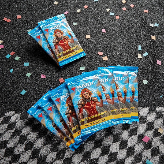 Blue Aetherdrift booster packs featuring Chandra in armor, spread on a gray surface with colorful confetti.