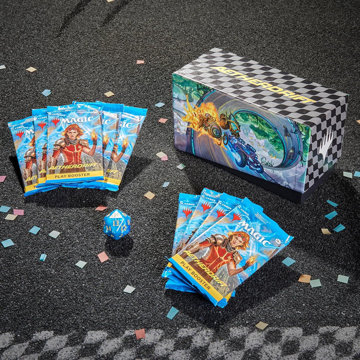 Checkered racing-themed card box, nine blue play booster packs, and a blue D20 on dark asphalt with colorful confetti.
