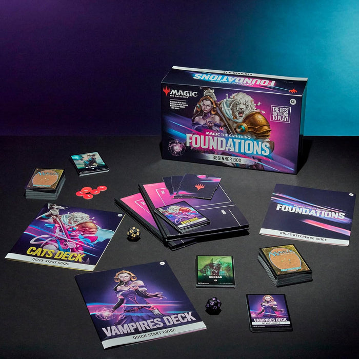Magic Foundations box with pink and purple branding, card decks, and dice spread across a dark surface.
