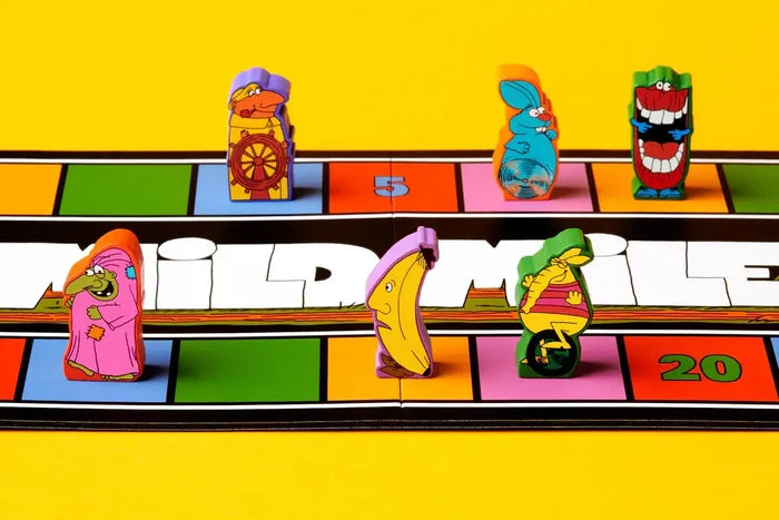 Six quirky wooden character tokens, including a banana and a rabbit, on a colorful square-tiled racing board.