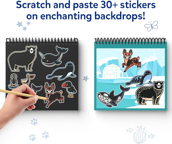Hand using a stylus to reveal animal stickers on a black page next to a colorful arctic backdrop filled with stickers.