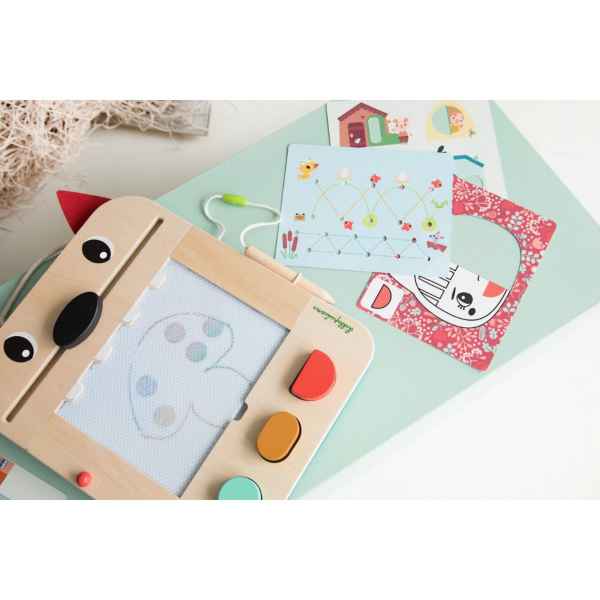Wooden wolf-shaped magnetic slate with stylus, colorful stamps, and activity cards on a light teal surface.
