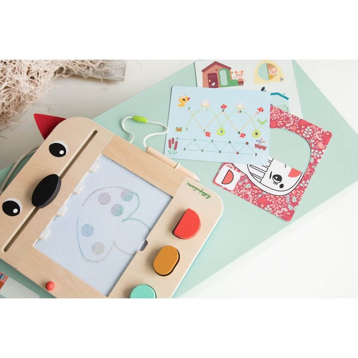 Wolf-themed wooden magnetic drawing board with stylus, stamps, and illustrated stencils on a light blue surface.