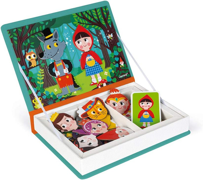 Open teal book-shaped box with white page edges, forest scene lid, Red Riding Hood, and character magnets in a tray.