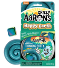 Teal magnetic putty swirl, metal tin, and iridescent square magnet in front of green cartoon Earth packaging.