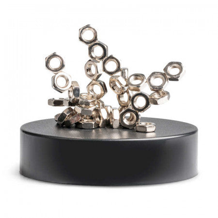 Silver hexagonal nuts clustered in a gravity-defying sculpture on top of a round black magnetic base.