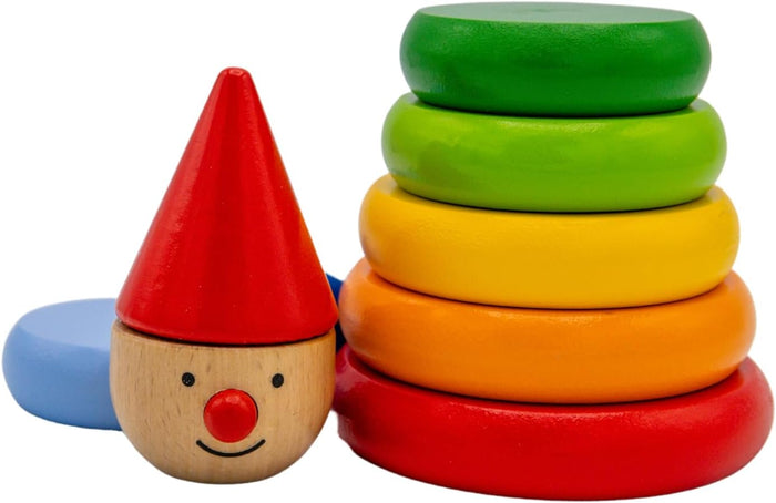 Colorful wooden stacking rings beside a smiling wooden character head with a red cone hat and red nose.
