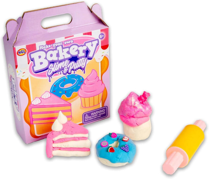 Purple bakery box kit with a pink cake slice, blue donut with fruit charms, pink cupcake, and a yellow rolling pin.