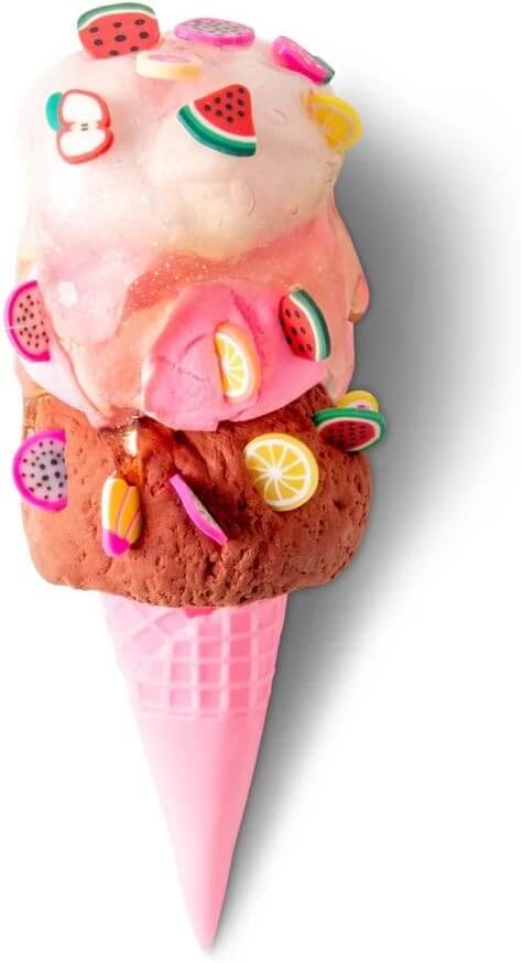 White, pink, and brown slime scoops in a pink cone, decorated with tiny fruit-shaped charms like watermelon slices.