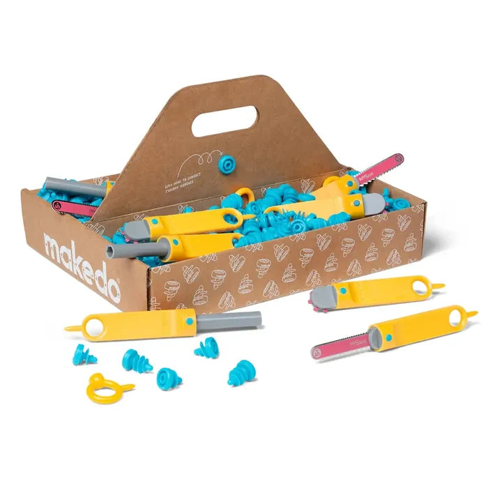 Cardboard toolbox filled with bright blue plastic screws and yellow-handled tools with some scattered in front.