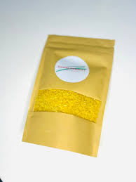 Resealable kraft paper pouch with a clear window showing bright yellow sensory rice and a circular white logo.