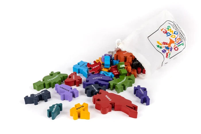 Colorful wooden puzzle pieces labeled with Irish county names spilling from a white drawstring storage bag.