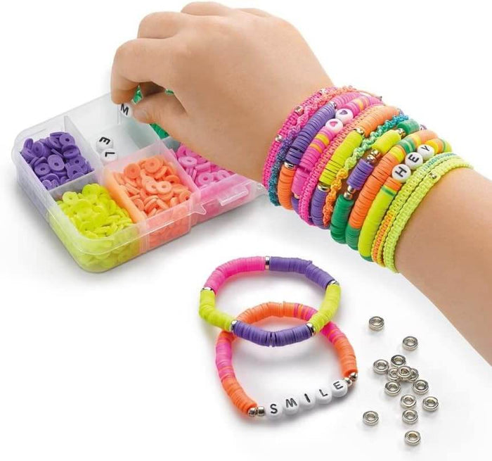 Hand picking neon beads from an organizer to make flat disc and letter bracelets worn on a child's wrist.