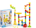 Colorful plastic marble run with towers, gears, and ramps next to its 60-piece Miniland brand product box.