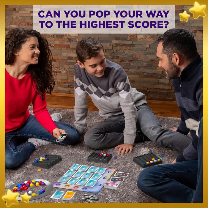 Smiling family playing a marble board game with colorful spheres, cards, and grooved trays on a rug.
