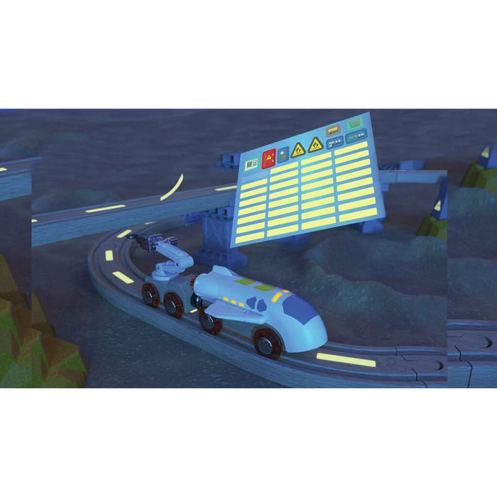 Blue toy spaceship train and robotic arm on a wooden track in a dark lunar landscape with a floating control panel graphic.