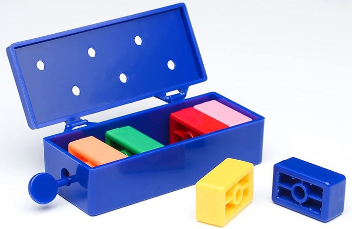 Open blue plastic magic box featuring colorful rectangular blocks in orange, green, red, pink, yellow, and blue.