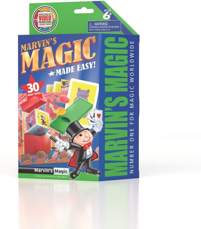 Green and blue magic kit box featuring a cartoon magician, playing cards, and 30 tricks for ages 6 and up.