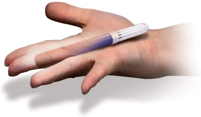 Magic illusion of a purple tube with a white cap appearing to pass through a person's finger on their palm.