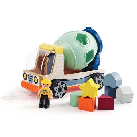 Wooden cement mixer toy with a green drum, small construction worker figure, and seven colorful shape-sorting blocks.