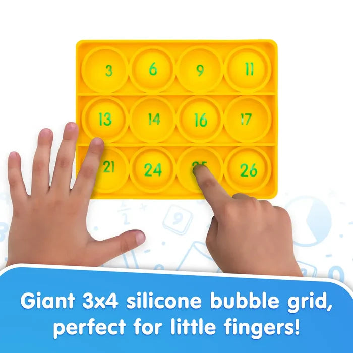 Yellow 3x4 silicone bubble popper toy with green numbers, being pressed by a child's hands.
